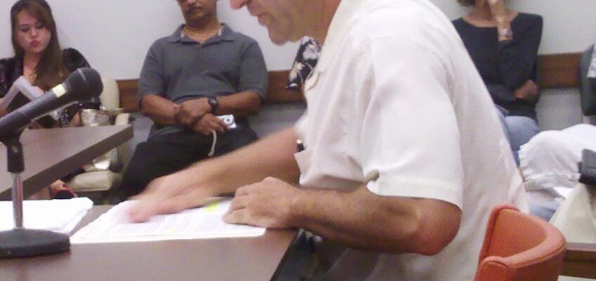 Man speaking at meeting with microphone