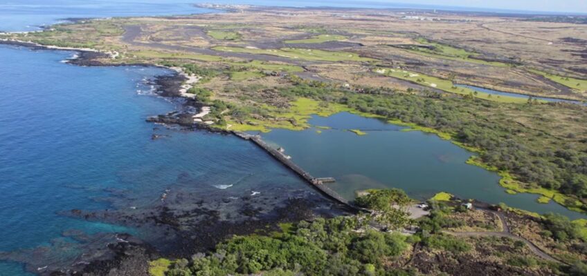 Aerial coastal lagoon with jetty and rocky shore