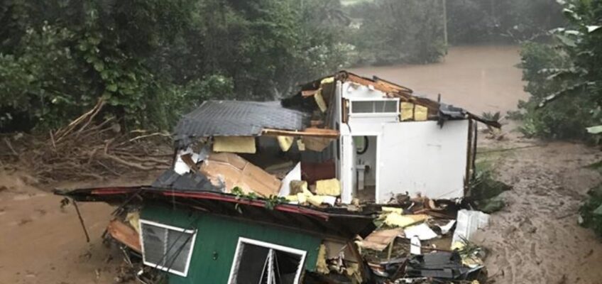Collapsed house swept away by floodwaters