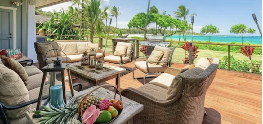 Tropical oceanfront deck with wicker seating