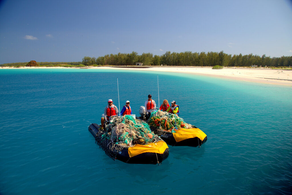 The team with two small boats piled with derelict fishing gear and nets