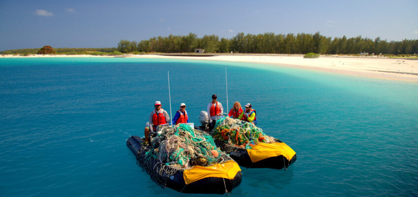 The team with two small boats piled with derelict fishing gear and nets