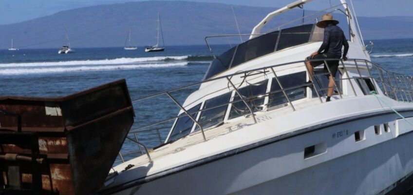 Beached motor yacht with person on deck